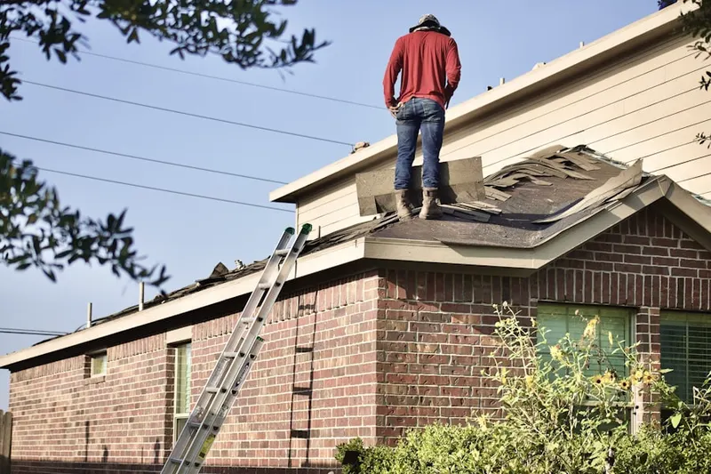 Professional roofer working on a residential roof in Roosevelt Park